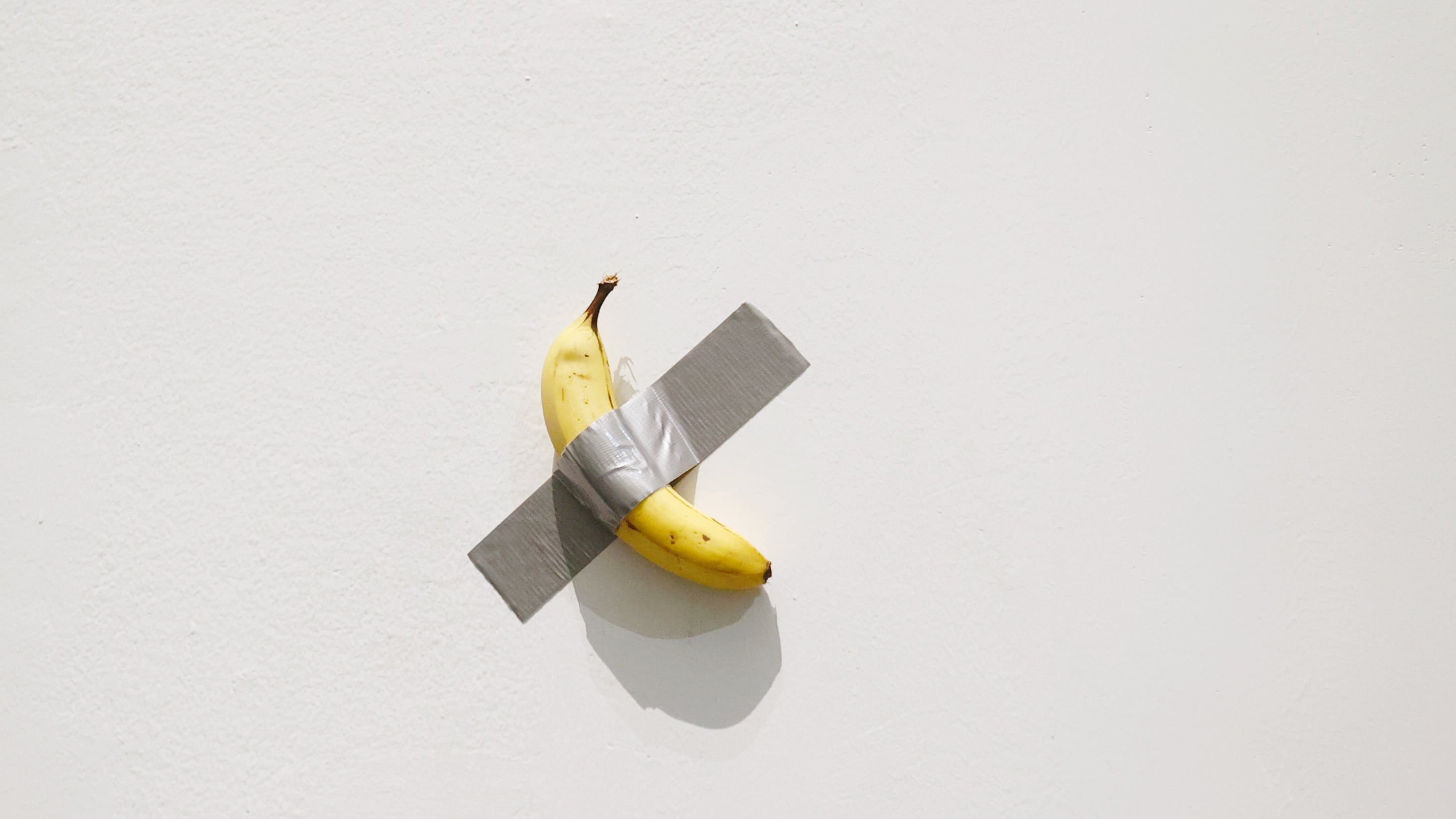 A banana duct-taped to a wall.